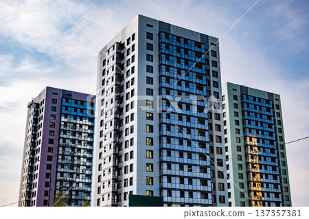 Modern residential towers soaring against urban sky, symbolizing city living and development 137357381