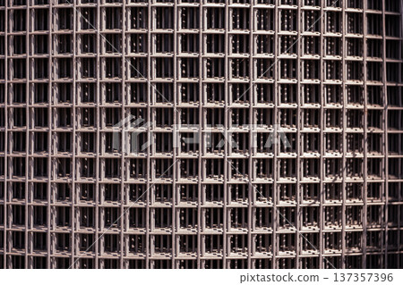 Steel wire mesh forming a repetitive geometric pattern and industrial background texture Steel wire mesh forming a repetitive geometric pattern and industrial background texture 137357396