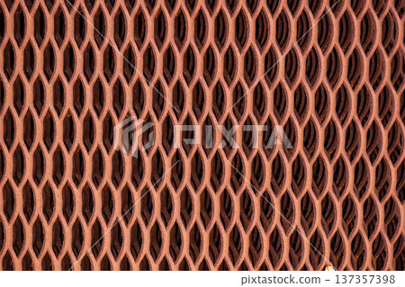 Rusted metal security mesh forming a detailed geometric texture pattern 137357398