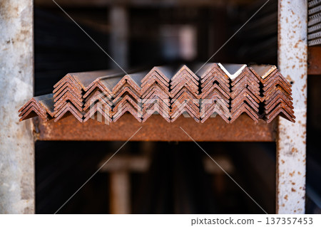 Stacking rusty metal angle bars, preparing for construction and industrial projects Stacking rusty metal angle bars, preparing for construction and industrial projects 137357453