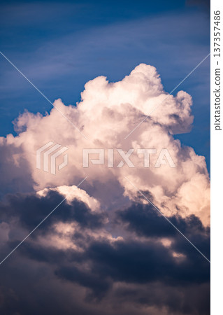 Clouds building in blue sky, showing atmospheric conditions and changing weather Clouds building in blue sky, showing atmospheric conditions and changing weather 137357486
