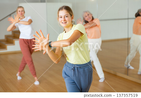 Girl performing dance during group training in studio 137357519