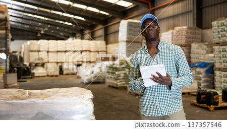 Portrait of focused African-American man checking order list 137357546