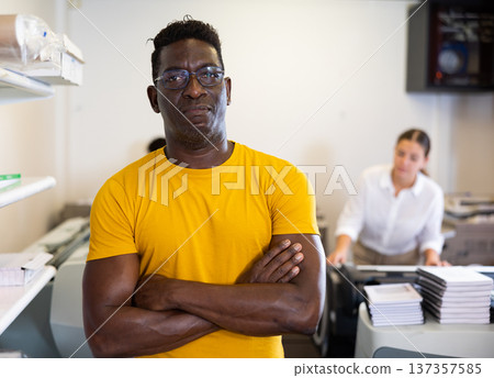 Portrait of African American middle-aged male with crossed hands on chest in the printer shop 137357585