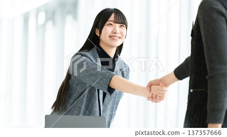 Young women and businesswomen shaking hands Young women and businesswomen shaking hands 137357666