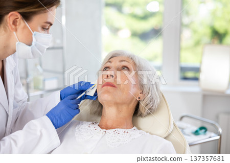 Elderly patient getting lip fillers. Elderly patient getting lip fillers. 137357681