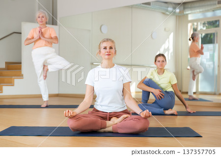 Woman practice yoga lotus pose Woman practice yoga lotus pose 137357705