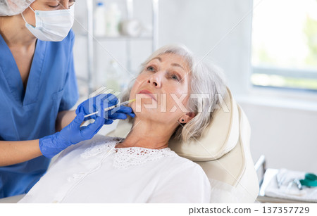 Elderly patient getting lip fillers. Elderly patient getting lip fillers. 137357729