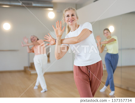 Woman dancing during group rehearsal in studio Woman dancing during group rehearsal in studio 137357734