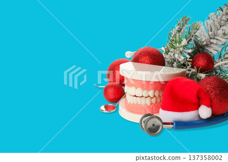 Dental model surrounded by holiday decorations and tools Dental model surrounded by holiday decorations and tools 137358002