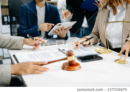business people and lawyers discussing contract papers sitting at the table. Concepts of law, advice, legal services. business people and lawyers discussing contract papers sitting at the table. Concepts of law, advice, legal services. 137358874