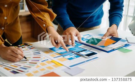 UX developer and ui designer brainstorming about mobile app interface wireframe design with customer breif and color code UX developer and ui designer brainstorming about mobile app interface wireframe design with customer breif and color code 137358875