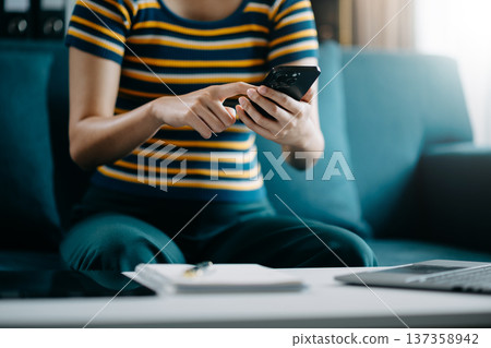 Confident businesswoman working on laptop,tablet and smartphone at her workplace at office. Confident businesswoman working on laptop,tablet and smartphone at her workplace at office. 137358942