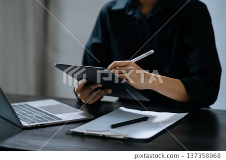Businessman hand using smart phone laptop and tablet with social network diagram on desk Businessman hand using smart phone laptop and tablet with social network diagram on desk 137358968