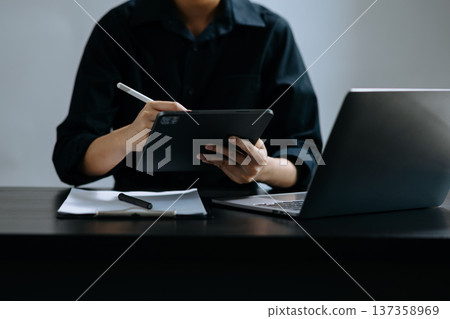 Businessman hand using smart phone laptop and tablet with social network diagram on desk 137358969