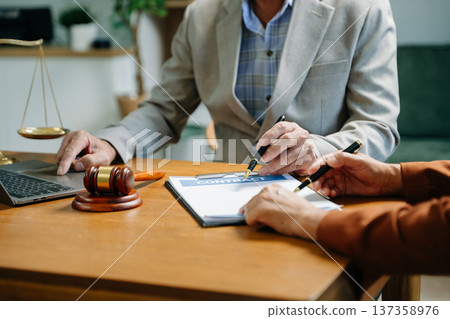 Business and Male lawyer or judge consult having team meeting with client, Law and Legal services Business and Male lawyer or judge consult having team meeting with client, Law and Legal services 137358976
