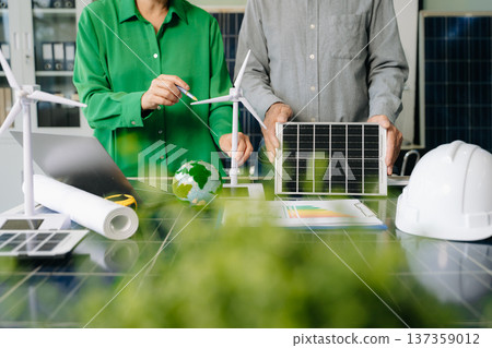 Engineers collaborate on solar and wind energy, driving sustainability, innovation, and clean tech solutions. Engineers collaborate on solar and wind energy, driving sustainability, innovation, and clean tech solutions. 137359012