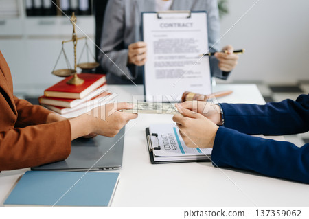 Lawyer refusing bribe money in the envelop from business man at lawyer office. Lawyer refusing bribe money in the envelop from business man at lawyer office. 137359062