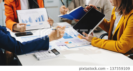 Businessman and team analyzing financial statement Finance task. with smart phone and laptop and  tablet. 137359109