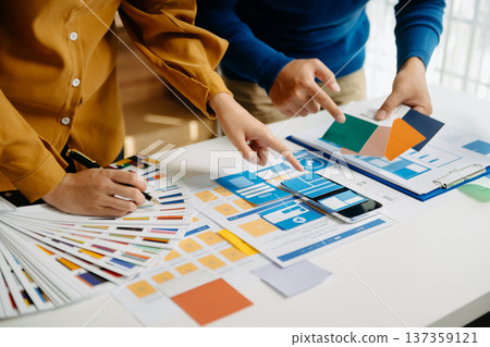 UX developer and ui designer brainstorming about mobile app interface wireframe design with customer breif and color code 137359121