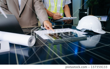 Engineers collaborate on solar and wind energy, driving sustainability, innovation, and clean tech solutions. Engineers collaborate on solar and wind energy, driving sustainability, innovation, and clean tech solutions. 137359133