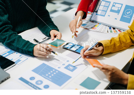 Close up view of UI developer team brainstorming on their project with laptop, smartphone and digital tablet. 137359138