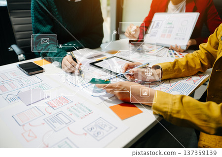 Close up view of UI developer team brainstorming on their project with laptop, smartphone and digital tablet. 137359139