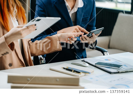 Businessman and team analyzing financial statement Finance task. with smart phone and laptop and tablet. Businessman and team analyzing financial statement Finance task. with smart phone and laptop and tablet. 137359141
