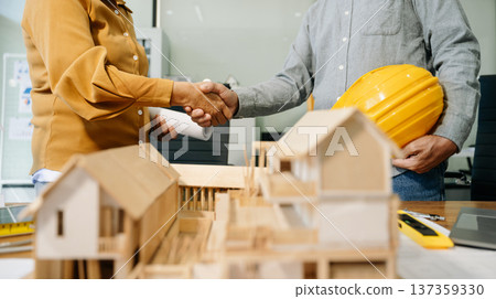 Construction team shake hands greeting start new project plan behind yellow helmet on desk in Construction team shake hands greeting start new project plan behind yellow helmet on desk in 137359330