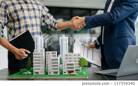 balancing the property sector The real estate agent is explaining the house style to see the house design and the purchase agreement. house 137359340