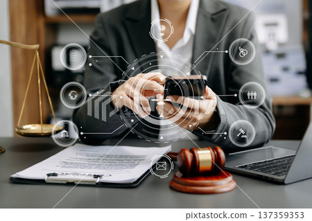 Male judge in a courtroom the gavel, working with smart phone and laptop and digital tablet computer with VR icon. justice and law concept. Male judge in a courtroom the gavel, working with smart phone and laptop and digital tablet computer with VR icon. justice and law concept. 137359353