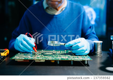 Professional electronics engineer testing a circuit board in a modern laboratory, concept of technology, repair, innovation, engineering 137359382