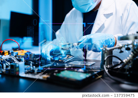 Professional technician repairing hard drive for data recovery in modern technology lab. Digital storage, cybersecurity, hardware repair and data protection concept. 137359475