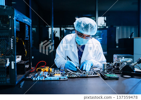 Professional electronics technician repairing computer motherboard in modern lab. Hardware engineering, cybersecurity, data technology, server maintenance 137359478