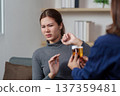 Patient Consultation. A healthcare professional discussing medication options with a hesitant patient. 137359481