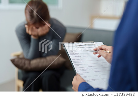 Therapeutic Session. Woman expresses vulnerability during a health summary review. Therapeutic Session. Woman expresses vulnerability during a health summary review. 137359488
