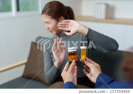 Medication Discussion. Therapist presenting medication options to patient in distress. Medication Discussion. Therapist presenting medication options to patient in distress. 137359489