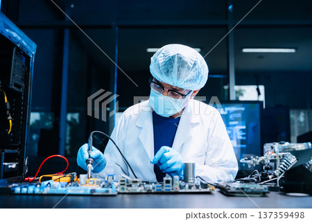Professional electronics technician repairing computer motherboard in modern lab. Hardware engineering, cybersecurity, data technology, server maintenance 137359498