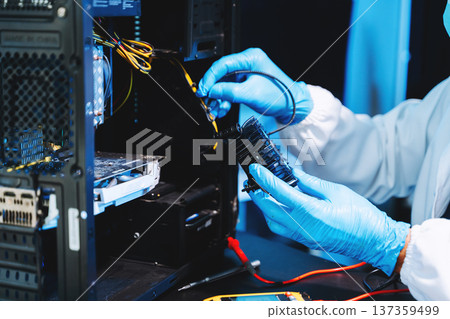 IT technician repairing computer hardware and cooling fan inside server system. Technology maintenance, cybersecurity infrastructure, data center IT technician repairing computer hardware and cooling fan inside server system. Technology maintenance, cybersecurity infrastructure, data center 137359499