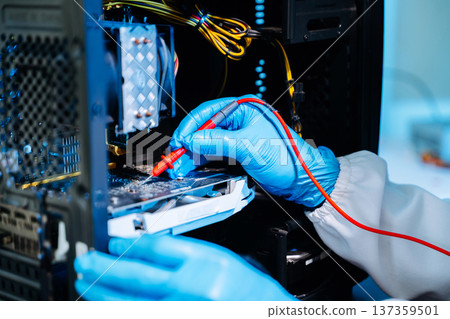 Technician repairing computer hardware inside PC case using heat gun tool. Electronics maintenance, motherboard upgrade 137359501