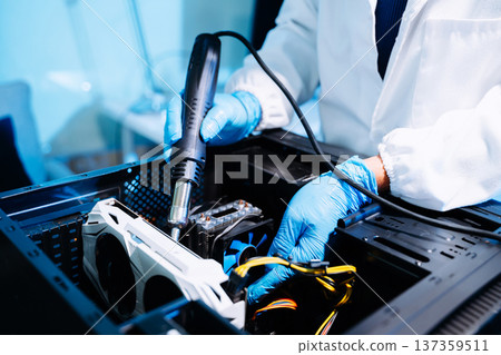 Technician repairing computer hardware inside PC case using heat gun tool. Electronics maintenance, motherboard upgrade 137359511