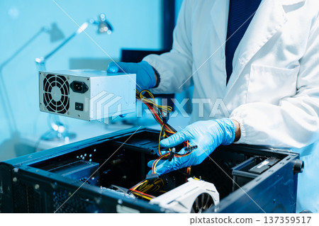 Professional technician repairing hard drive for data recovery in modern technology lab. Digital storage, cybersecurity, hardware repair and data protection concept. 137359517