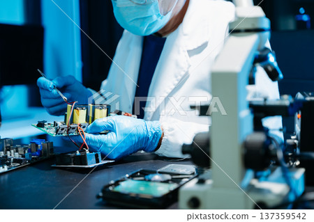 IT engineer repairing computer server hardware in laboratory. Electronics diagnostics, motherboard maintenance, cybersecurity infrastructure and data center IT engineer repairing computer server hardware in laboratory. Electronics diagnostics, motherboard maintenance, cybersecurity infrastructure and data center 137359542