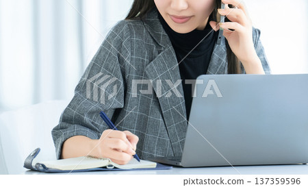 Young woman/businesswoman talking on smartphone 137359596
