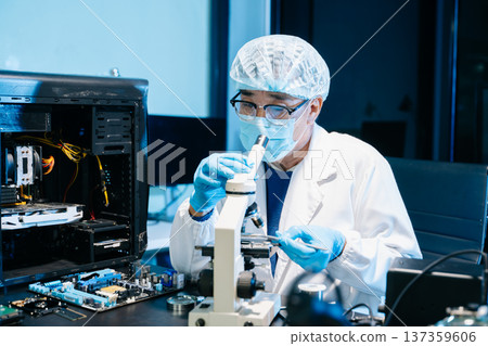 IT technician using microscope to inspect a motherboard in a modern lab. Electronics repair, precision work, troubleshooting, and system diagnostics 137359606