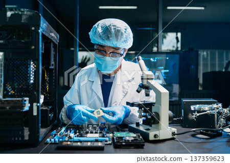 IT technician repairing smartphone and working on motherboard in a modern lab. Electronics, tech repair, digital tools, precision work IT technician repairing smartphone and working on motherboard in a modern lab. Electronics, tech repair, digital tools, precision work 137359623