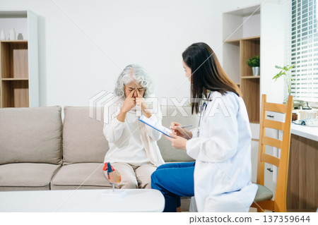 Healthcare professional using stethoscope to examine elderly woman at home. Senior medical checkup, heart health, home care, diagnosis, prevention Healthcare professional using stethoscope to examine elderly woman at home. Senior medical checkup, heart health, home care, diagnosis, prevention 137359644