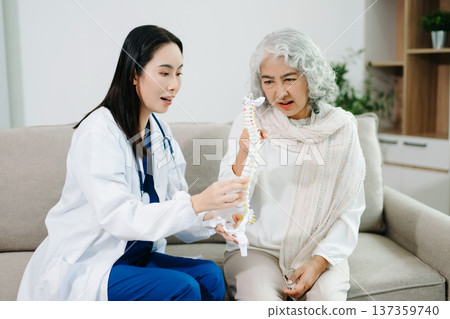 Doctor examining elderly woman with knee pain during home healthcare visit, highlighting arthritis treatment, senior support, medical consultation and compassionate care. Doctor examining elderly woman with knee pain during home healthcare visit, highlighting arthritis treatment, senior support, medical consultation and compassionate care. 137359740