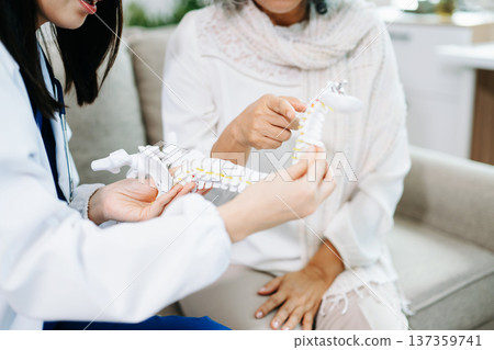Doctor examining elderly woman with knee pain during home healthcare visit, highlighting arthritis treatment, senior support, medical consultation and compassionate care. Doctor examining elderly woman with knee pain during home healthcare visit, highlighting arthritis treatment, senior support, medical consultation and compassionate care. 137359741
