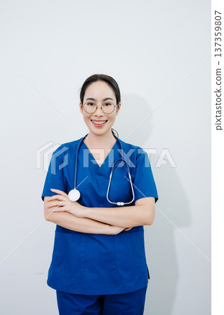 Confident Asian nurse in blue scrubs with stethoscope. Professional healthcare worker portrait for hospital, clinic, medical service, wellness Confident Asian nurse in blue scrubs with stethoscope. Professional healthcare worker portrait for hospital, clinic, medical service, wellness 137359807